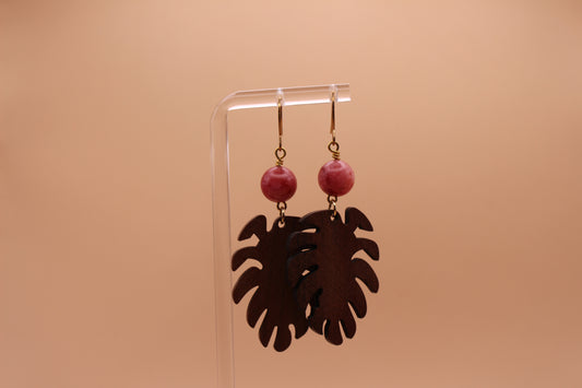 walnut monstera earrings with pink beads on a beige background